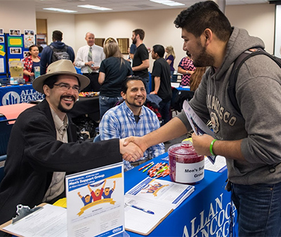 Counselors shaking hands with man