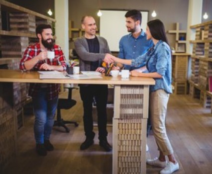 Employer shaking hands with employees